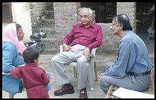Psychiatrists Naren Wig, center, and Arun Misra meet with Krishna Devi and her grandson Nikhil in Raipur Rani, India. Devi took part in a long-term study tracking patients with schizophrenia in poor and rich countries, and her doctors say that strong social supports played an important role in her recovery.