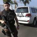 A Lebanese special forces policeman escorts the vehicles of U.N. experts on the arrival at the private jet terminal, at Beirut international airport in Lebanon on Saturday.