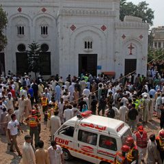 People gather outside a Christian church after twin suicide bombings at Sunday Mass in Peshawar, Pakistan.